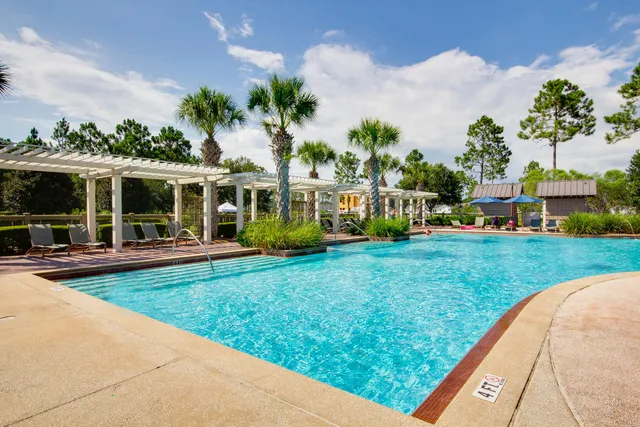 an aerial view of a house with a garden and swimming pool