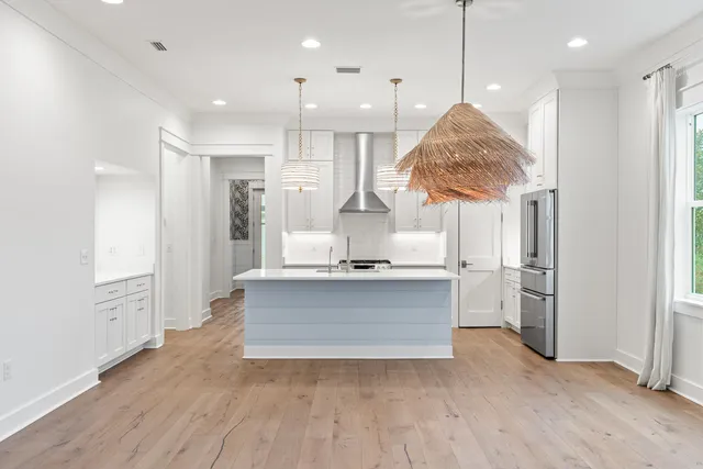 a large kitchen with stainless steel appliances granite countertop a granite counter tops and a wooden floors