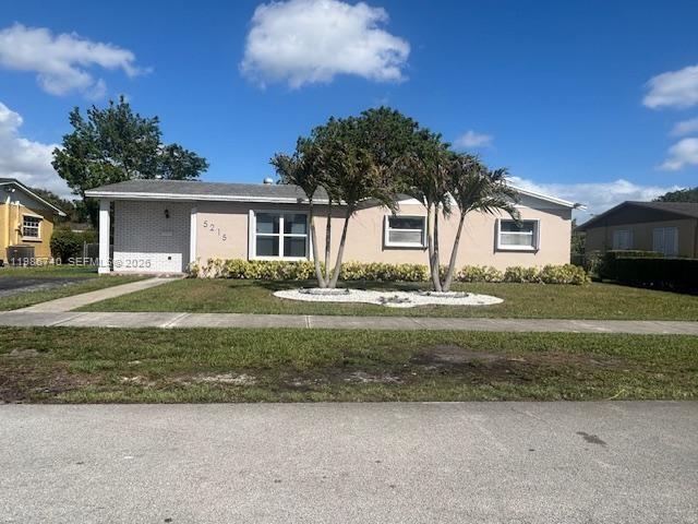 5215 Southwest 128th Avenue Miami, FL 33175 - Photo 1 of 20 a front view of a house with a garden