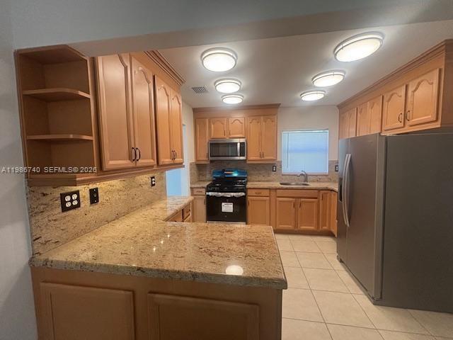 5215 Southwest 128th Avenue Miami, FL 33175 - Photo 13 of 20 a kitchen with granite countertop a refrigerator a stove and a sink