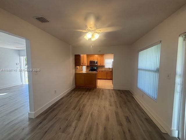 5215 Southwest 128th Avenue Miami, FL 33175 - Photo 14 of 20 wooden floor in an empty room with a kitchen