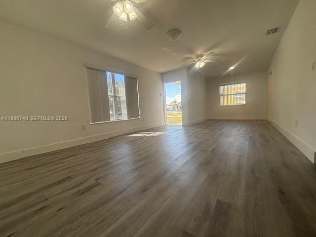 5215 Southwest 128th Avenue Miami, FL 33175 - Photo 3 of 20 a view of an empty room with wooden floor and a window