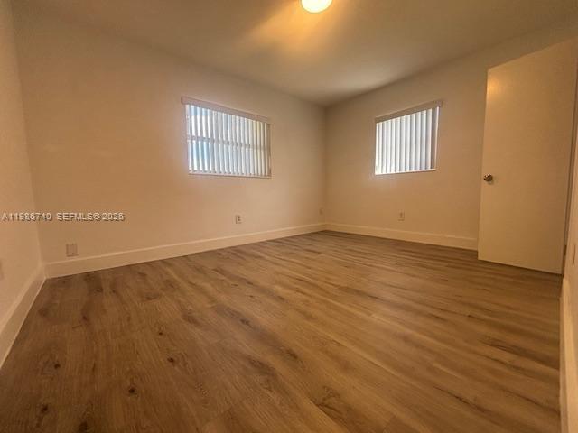 5215 Southwest 128th Avenue Miami, FL 33175 - Photo 6 of 20 a view of an empty room with wooden floor and a window