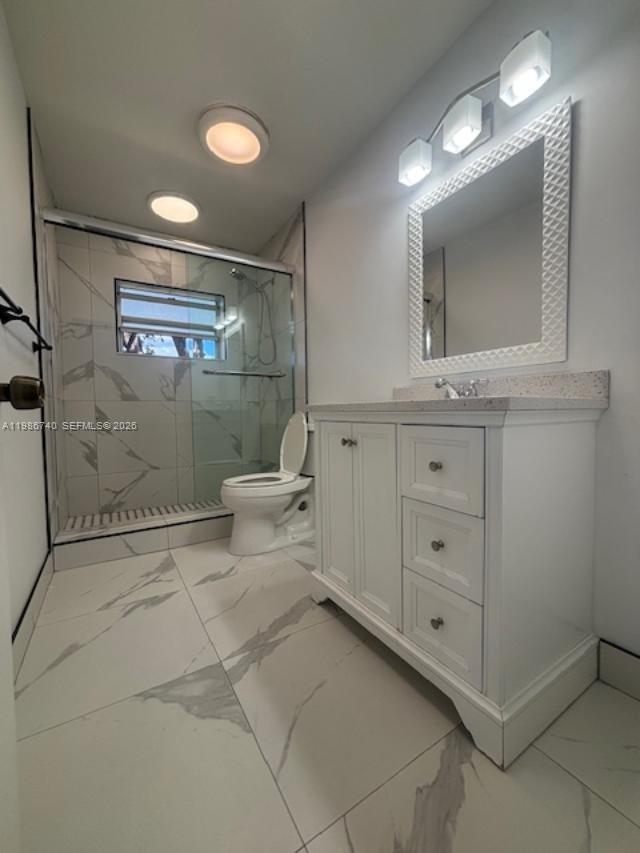 5215 Southwest 128th Avenue Miami, FL 33175 - Photo 8 of 20 a bathroom with a double vanity sink toilet and a mirror