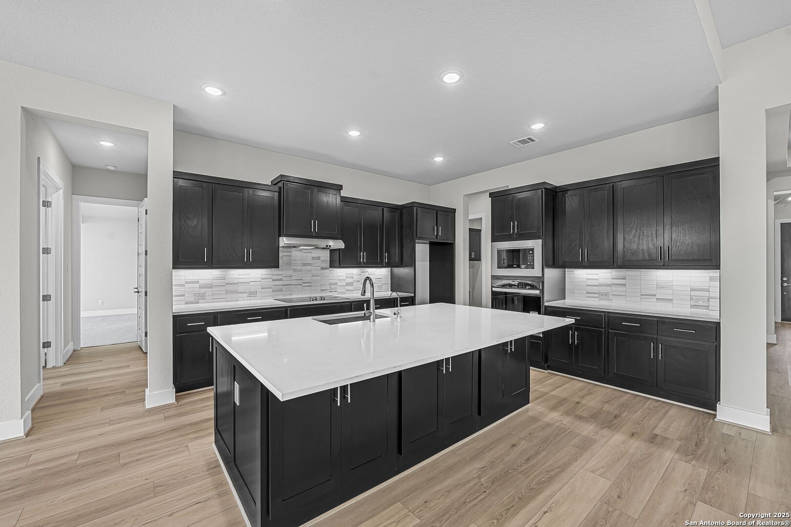 6821 Arbor Falls Fair Oaks Ranch, TX 78015 - Photo 12 of 50 a large kitchen with stainless steel appliances kitchen island granite countertop a stove and a refrigerator