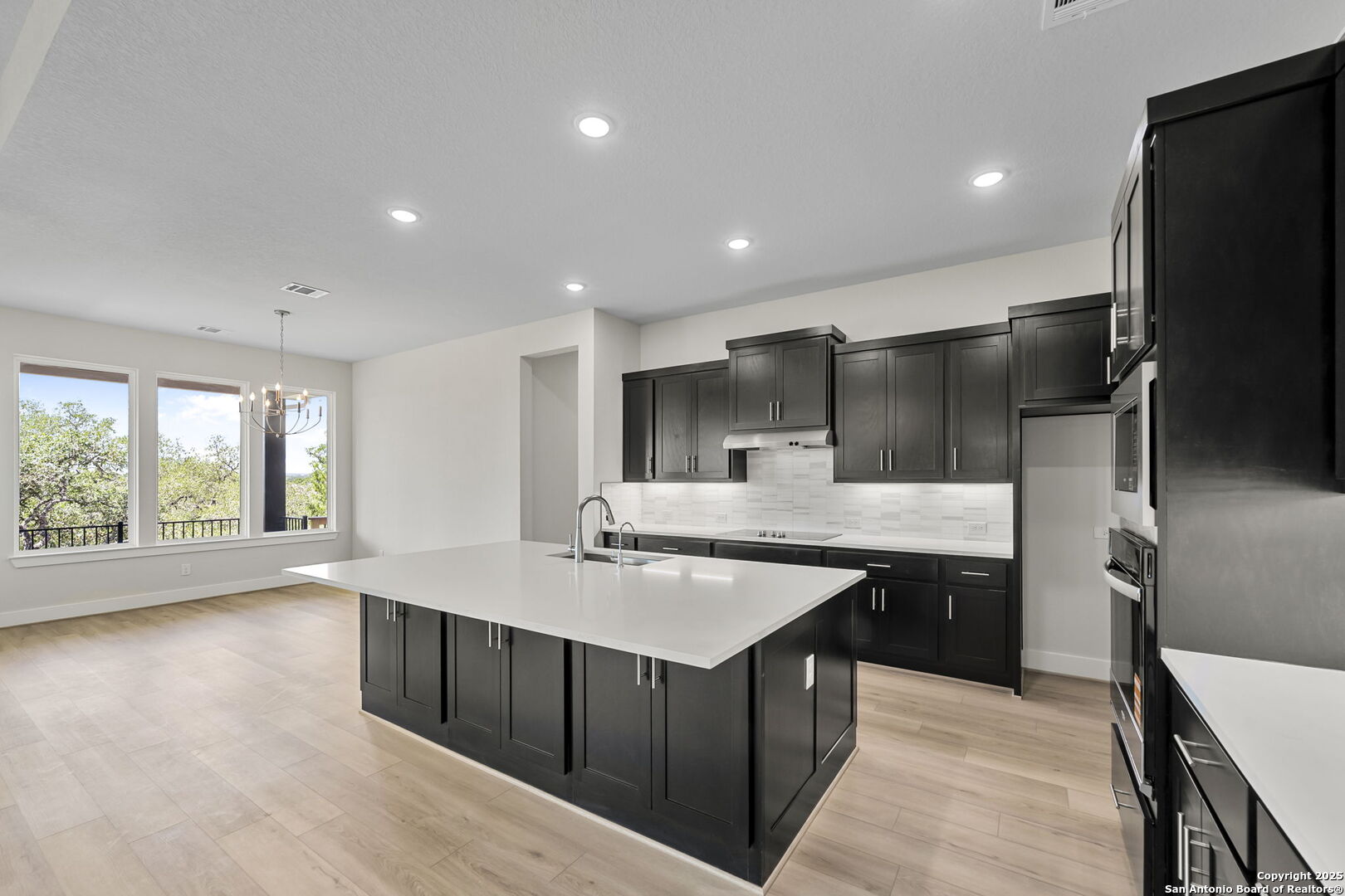6821 Arbor Falls Fair Oaks Ranch, TX 78015 - Photo 13 of 50 a kitchen with kitchen island a sink appliances and a counter top space