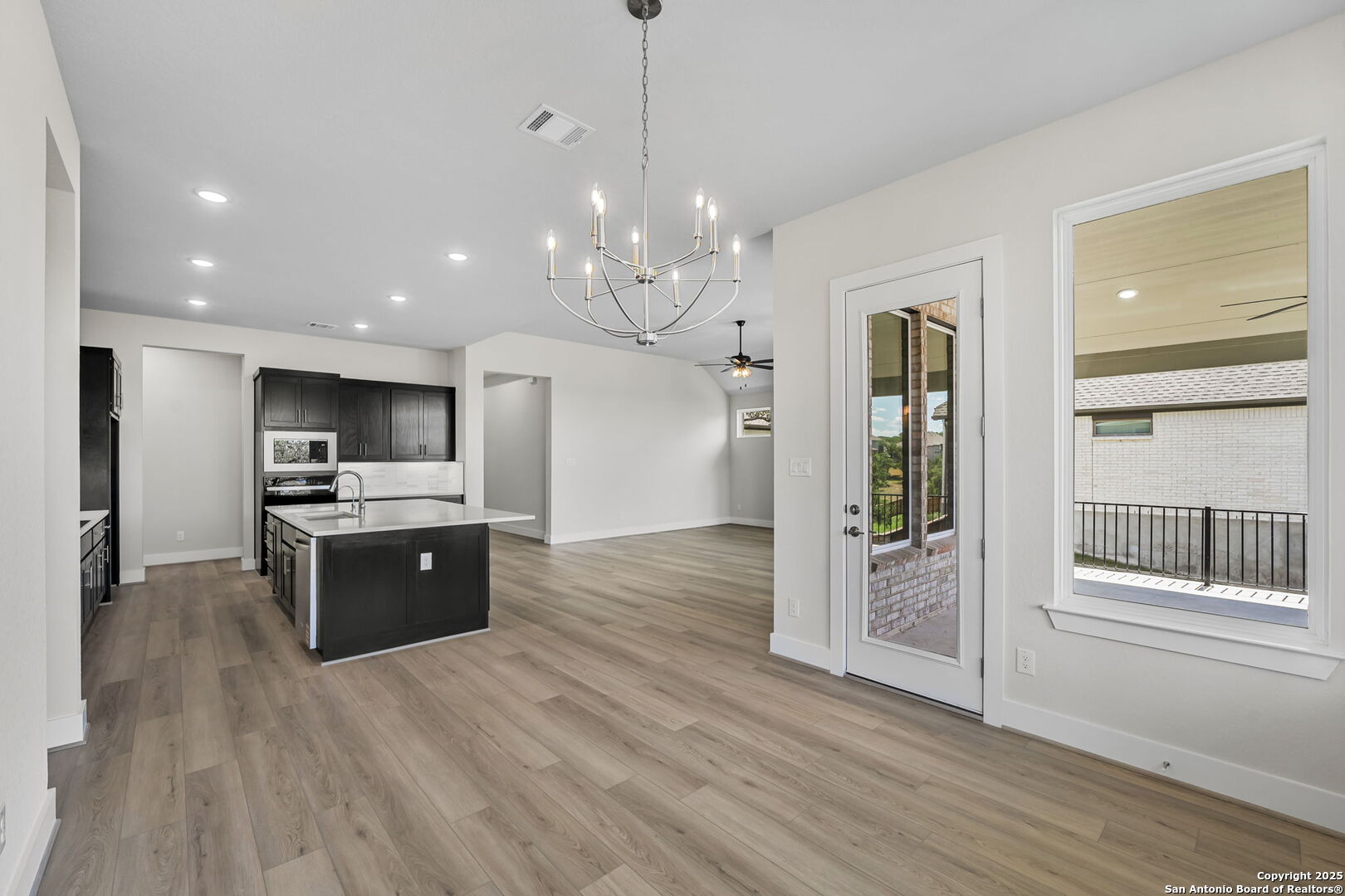 6821 Arbor Falls Fair Oaks Ranch, TX 78015 - Photo 17 of 50 a large kitchen with kitchen island a large counter space a sink appliances and cabinets