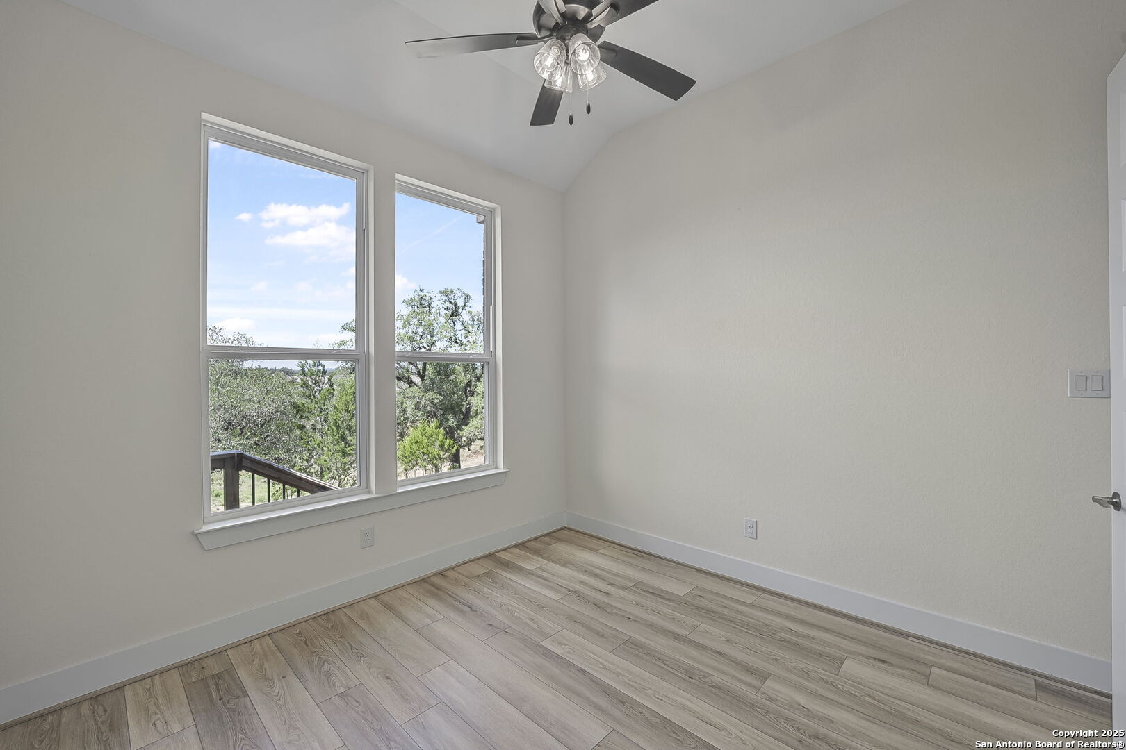 6821 Arbor Falls Fair Oaks Ranch, TX 78015 - Photo 19 of 50 wooden floor in an empty room with a window