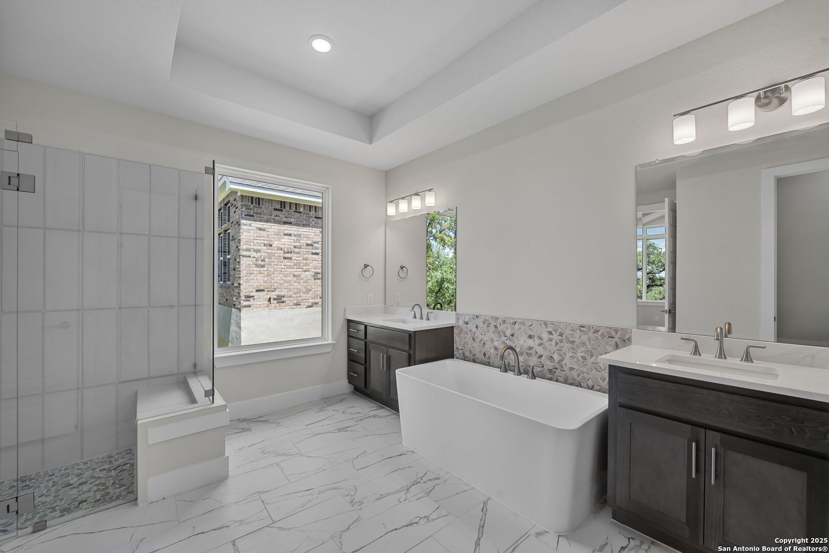 6821 Arbor Falls Fair Oaks Ranch, TX 78015 - Photo 23 of 50 a spacious bathroom with a granite countertop sink a toilet a mirror and bathtub