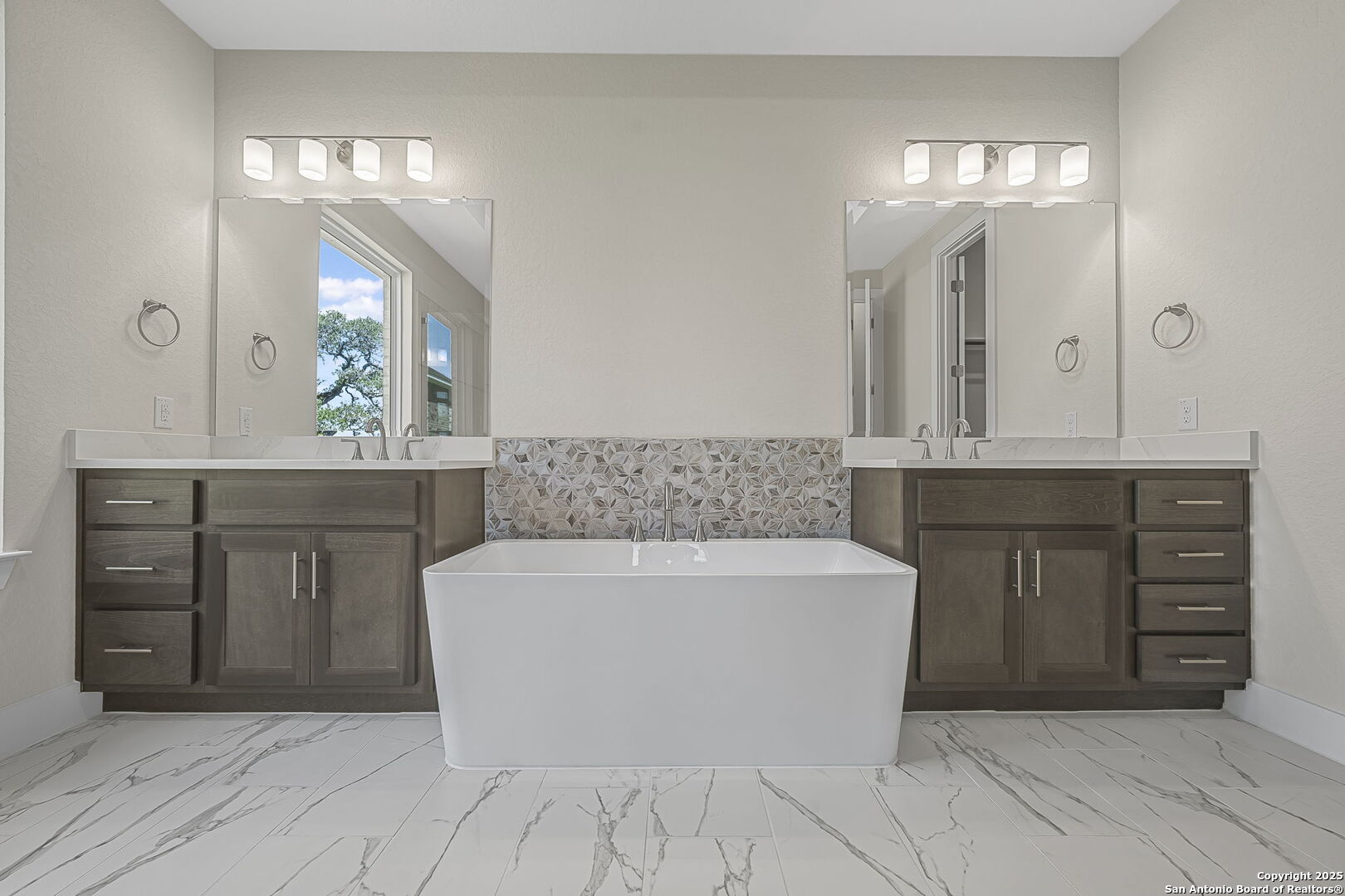 6821 Arbor Falls Fair Oaks Ranch, TX 78015 - Photo 25 of 50 a spacious bathroom with a tub a double vanity sink and a mirror