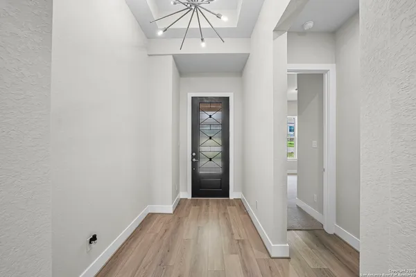 a view of a hallway with wooden floor