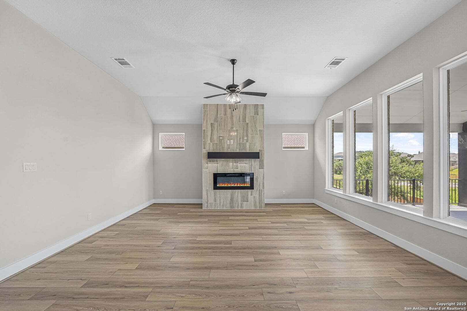 6821 Arbor Falls Fair Oaks Ranch, TX 78015 - Photo 10 of 50 a view of an empty room with a window and wooden floor