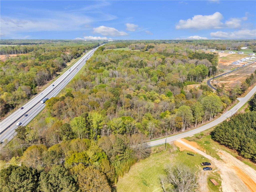Tbd Nannies Circle Pelzer, SC 29669 - Photo 4 of 13 Vast green landscapes surround a major highway and developing residential areas.