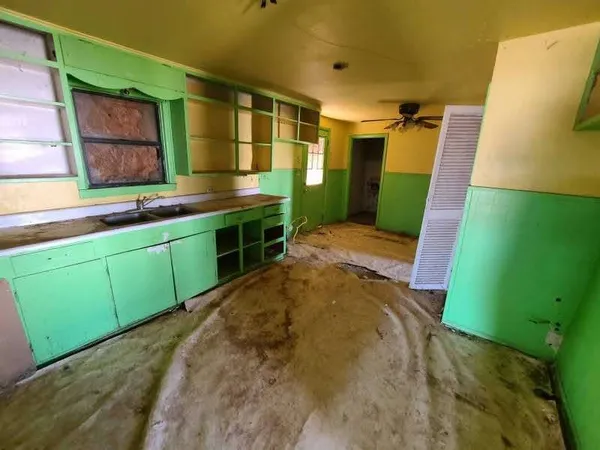a bathroom with a sink mirror and a window