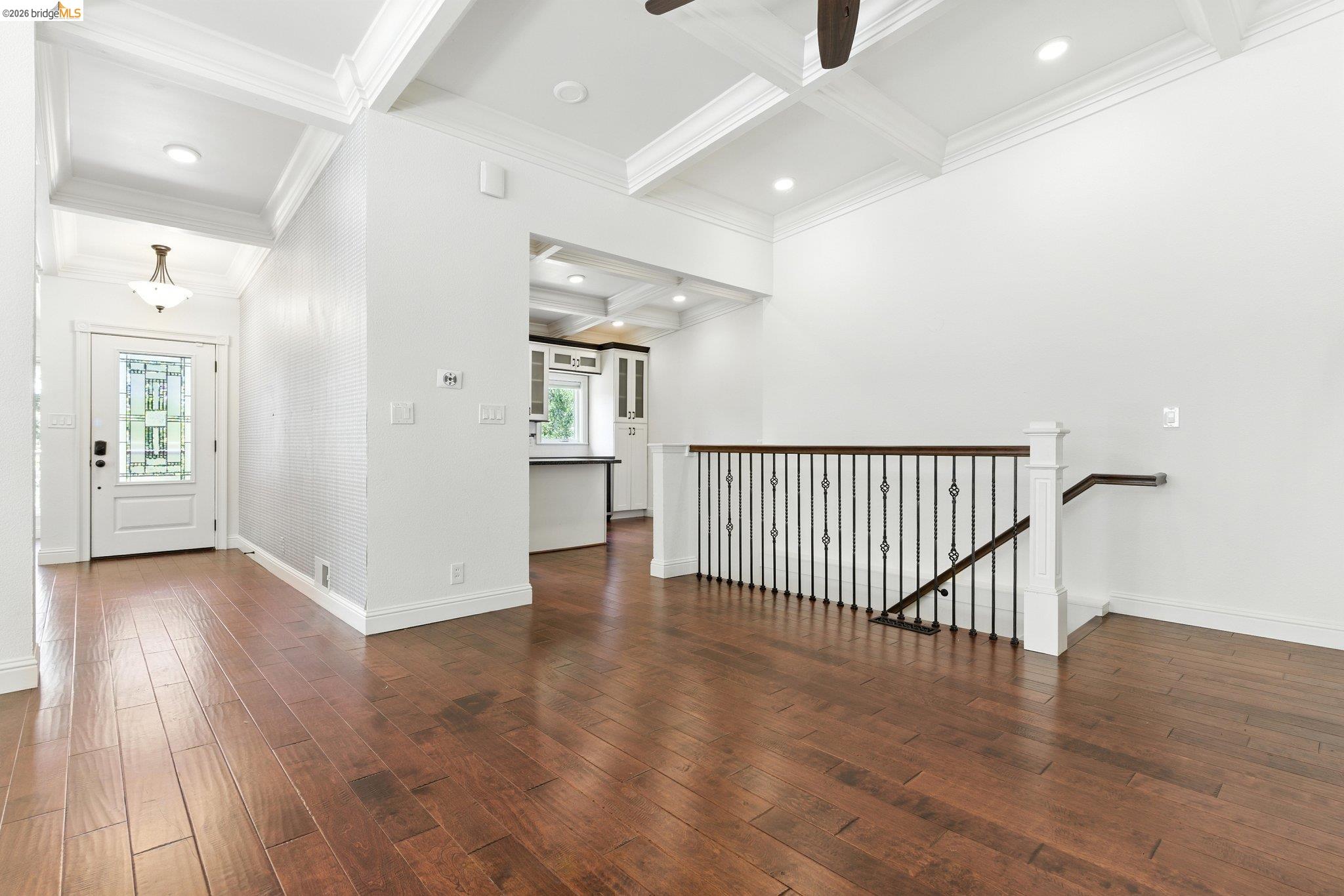 18 Conrad Court Oakland, CA 94611 - Photo 14 of 36 Entrance foyer with coffered ceiling, beamed ceiling, dark wood-style flooring, ornamental molding, and a ceiling fan