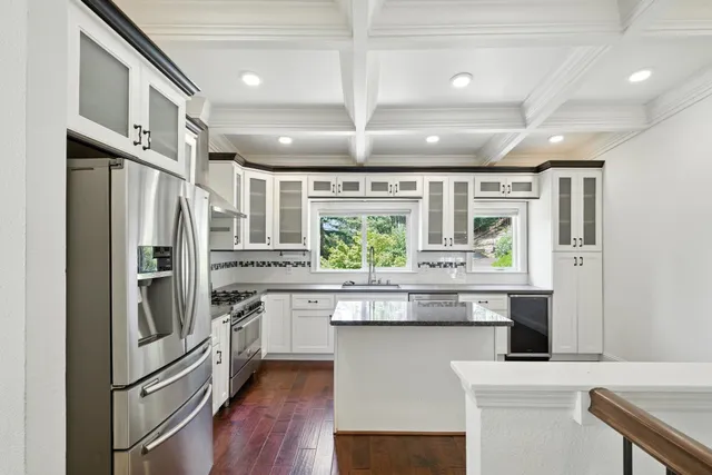 a kitchen with stainless steel appliances granite countertop a refrigerator and a sink