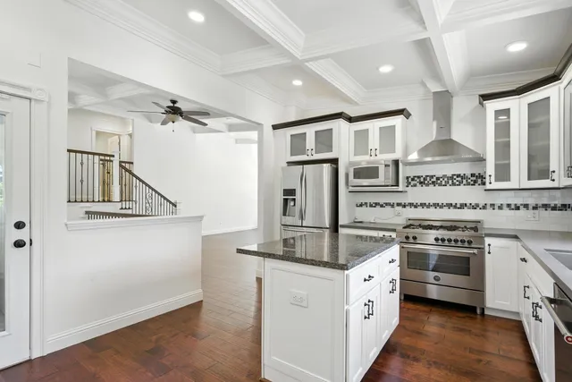 a kitchen with stainless steel appliances granite countertop a stove and a refrigerator