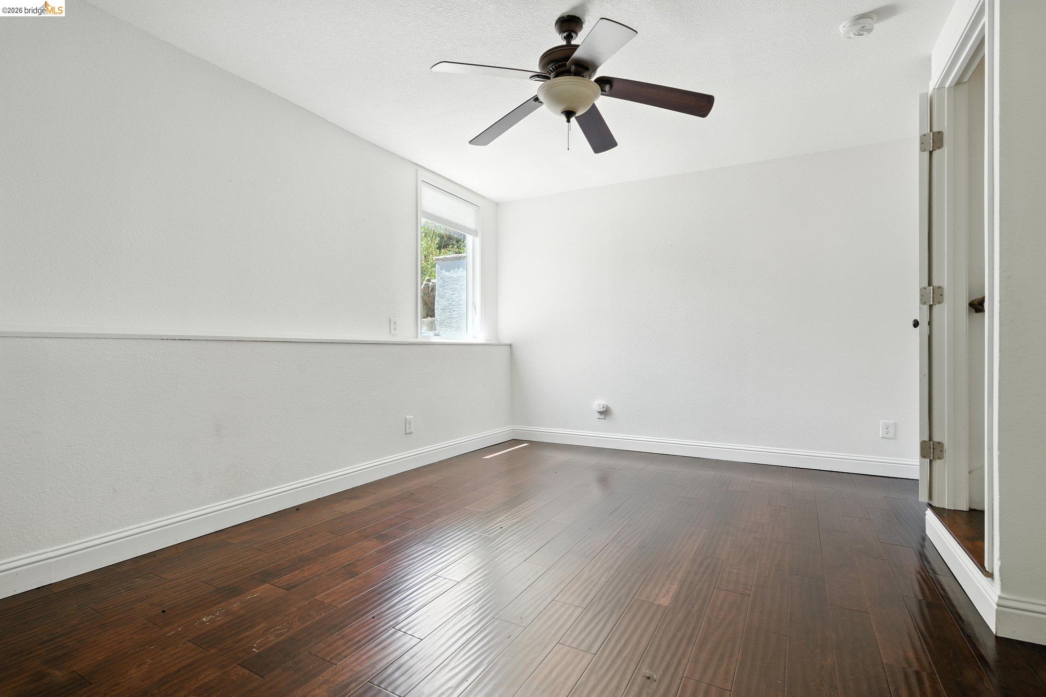 18 Conrad Court Oakland, CA 94611 - Photo 28 of 36 Unfurnished room featuring dark wood-style floors and ceiling fan