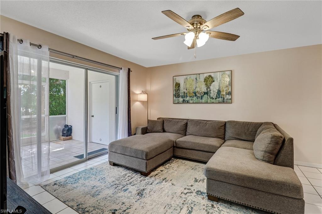7750 Jewel Lane, Unit 101 Naples, FL 34109 - Photo 11 of 28 a living room with furniture and a large window