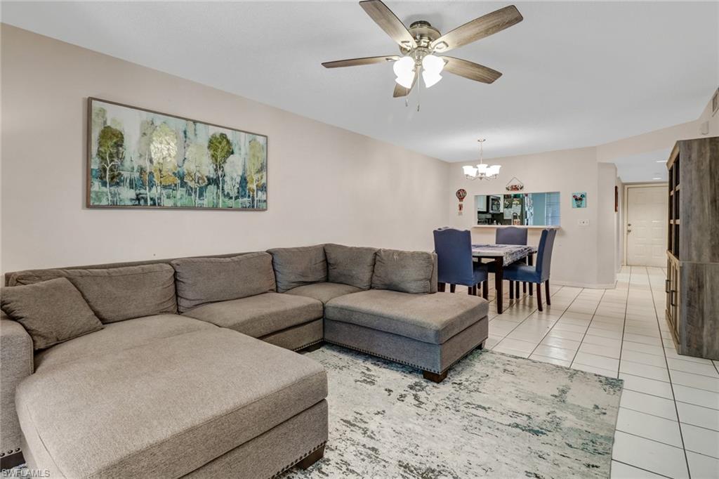 7750 Jewel Lane, Unit 101 Naples, FL 34109 - Photo 13 of 28 a living room with furniture a view of dining room and a couch