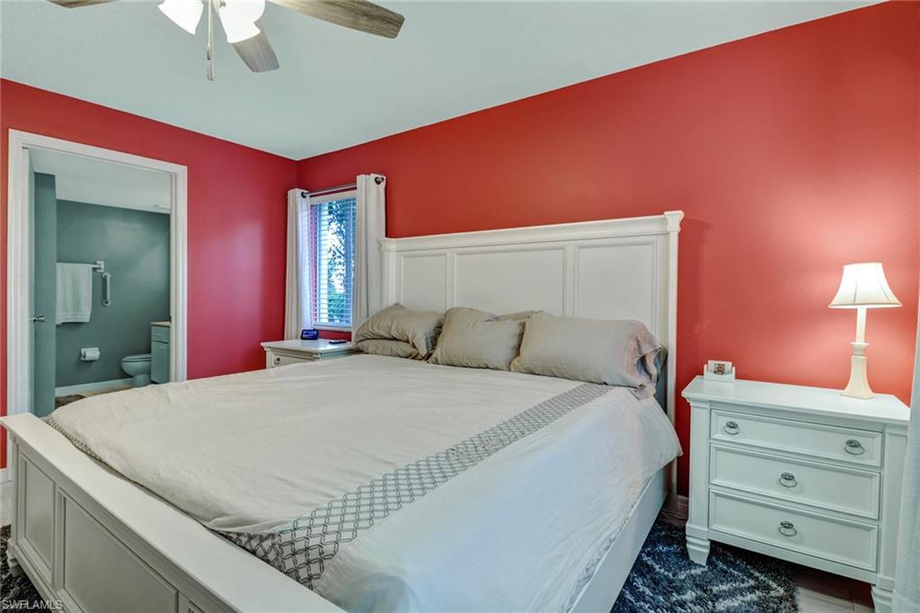 7750 Jewel Lane, Unit 101 Naples, FL 34109 - Photo 16 of 28 a bedroom with a bed and a dresser