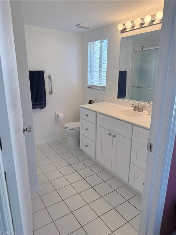 7750 Jewel Lane, Unit 101 Naples, FL 34109 - Photo 17 of 28 a spacious bathroom with a toilet sink and mirror