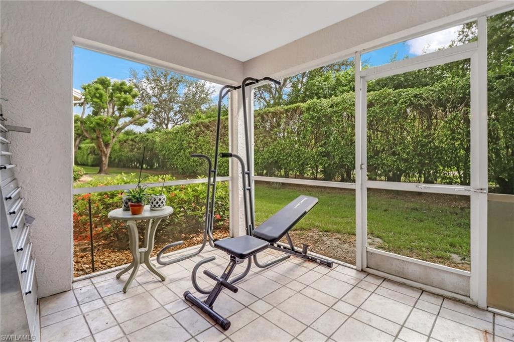 7750 Jewel Lane, Unit 101 Naples, FL 34109 - Photo 25 of 28 a view of a porch with chairs and backyard
