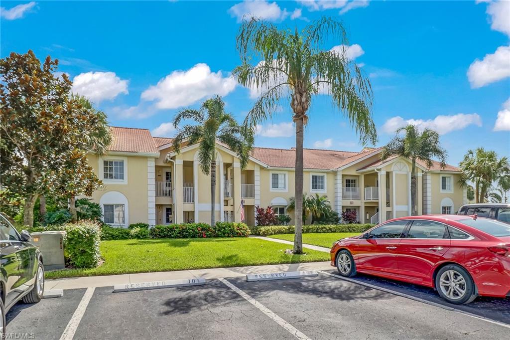 7750 Jewel Lane, Unit 101 Naples, FL 34109 - Photo 28 of 28 a front view of a house with a yard and garage