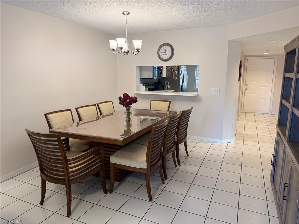 7750 Jewel Lane, Unit 101 Naples, FL 34109 - Photo 7 of 28 a view of a dining room with furniture