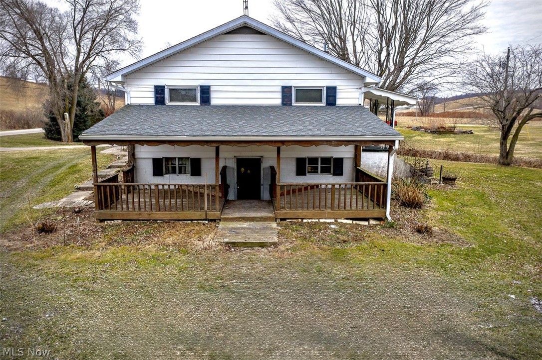 3336 Broad Run Dairy Road Northwest Dover, OH 44622 - Photo 7 of 26 View of side of home with a porch, roof with shingles, and a front yard