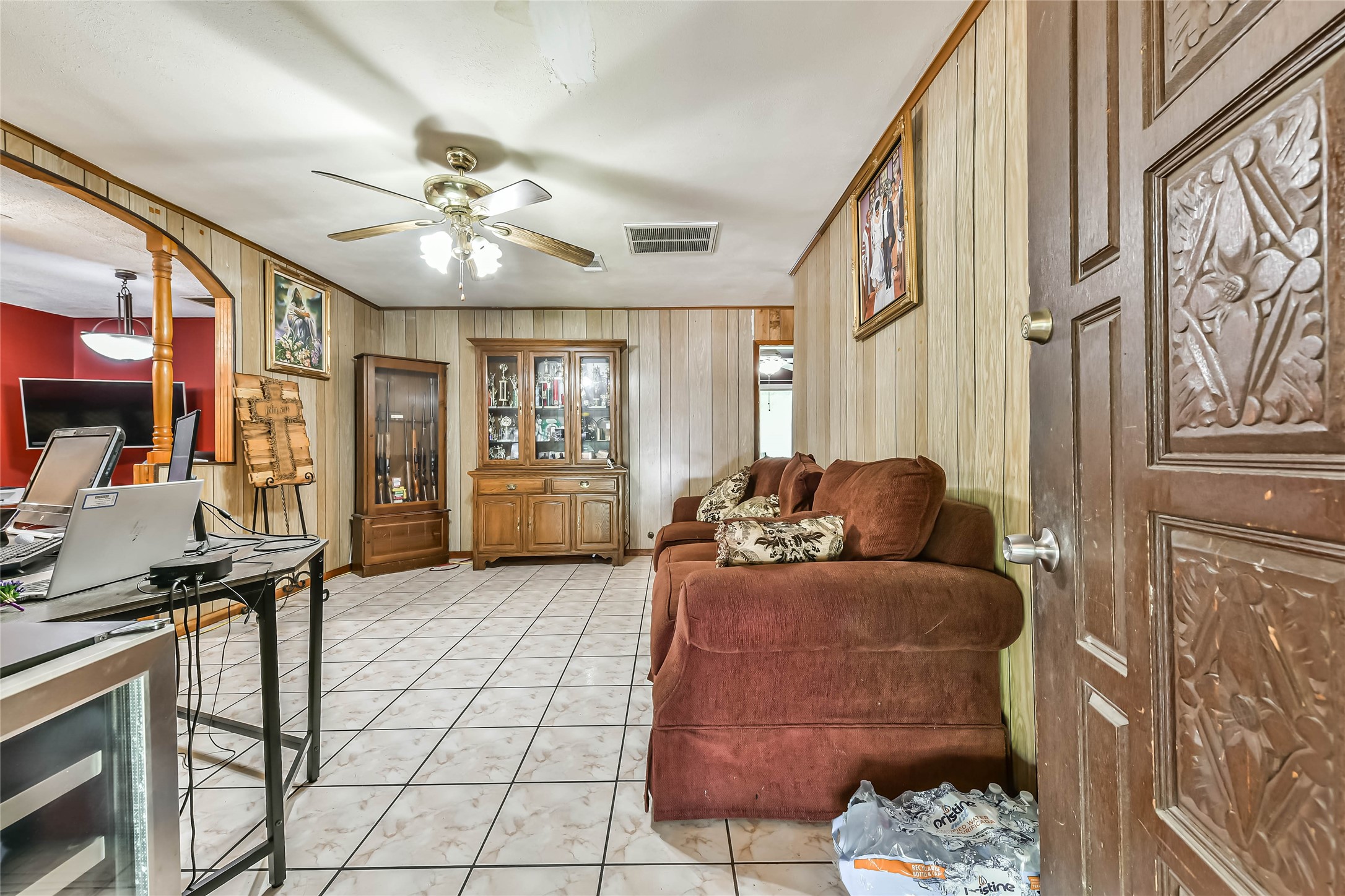 10438 Caxton Street Houston, TX 77016 - Photo 5 of 24 a living room with furniture and a flat screen tv