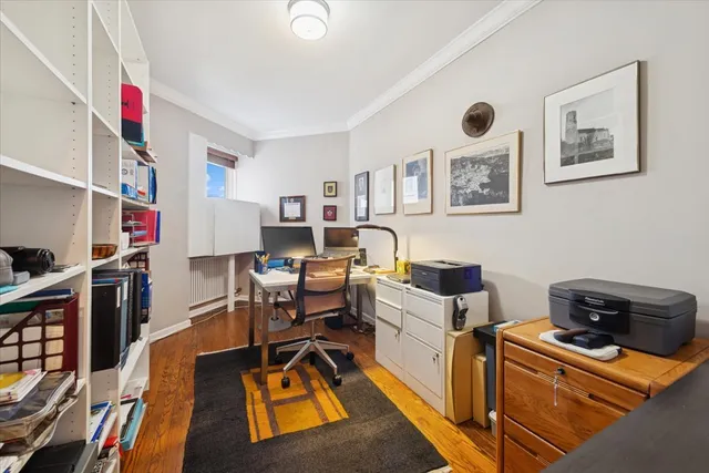 a work room with furniture and a book shelf