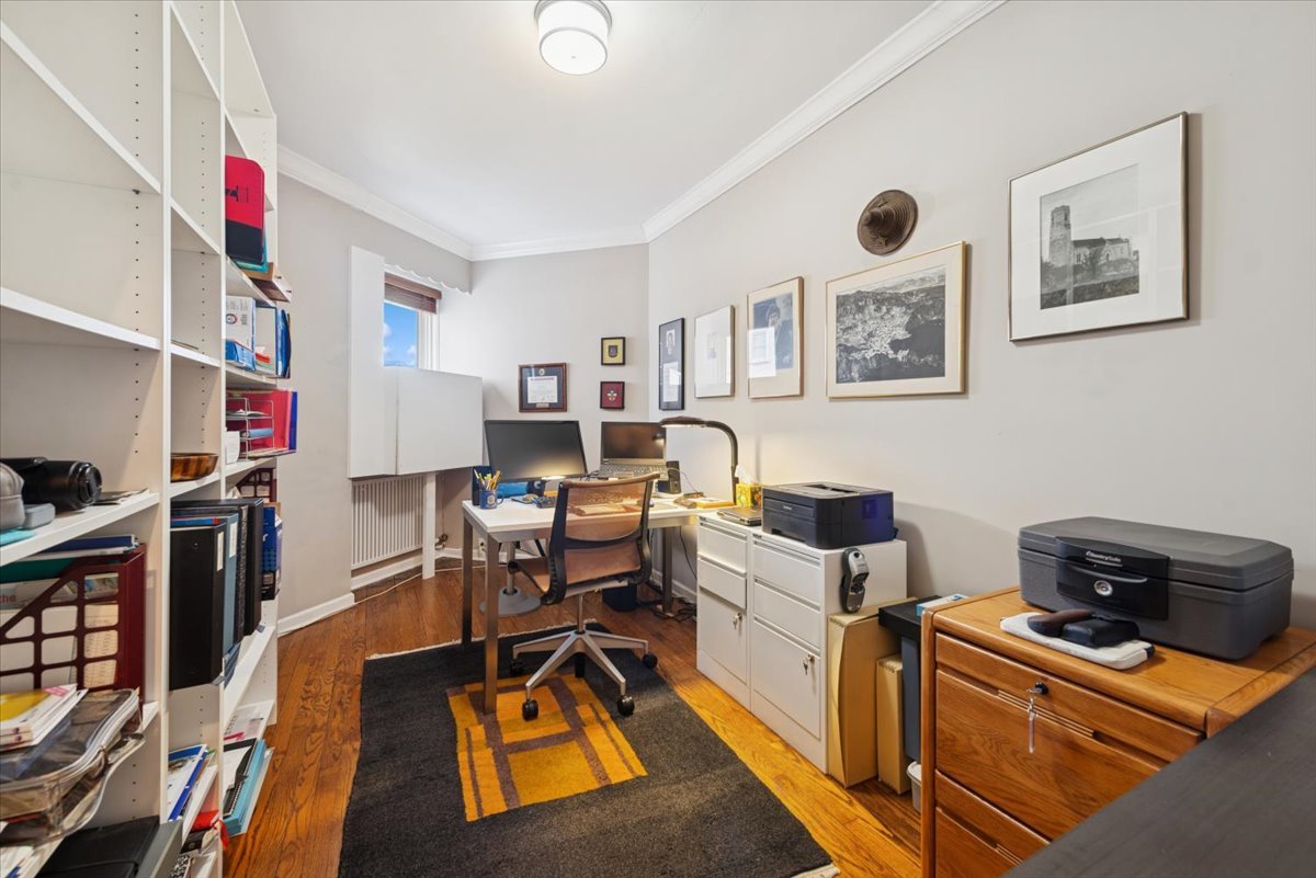 5555 North Sheridan Road, Unit 609 Chicago, IL 60640 - Photo 12 of 24 a work room with furniture and a book shelf