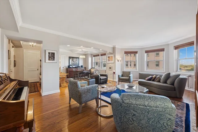 a living room with furniture wooden floor and a window