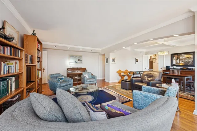 a living room with furniture and a book shelf