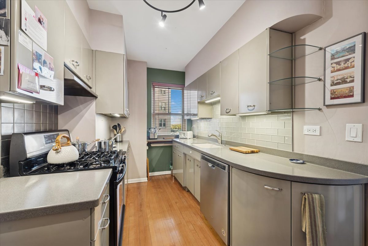 5555 North Sheridan Road, Unit 609 Chicago, IL 60640 - Photo 9 of 24 a kitchen with a sink and a stove top oven