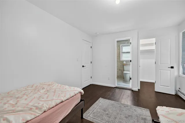 a bathroom with a sink a toilet a mirror and shower