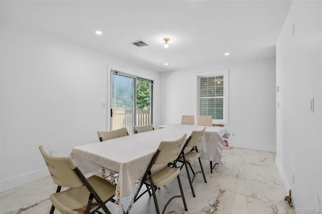a view of a dining room with furniture and window