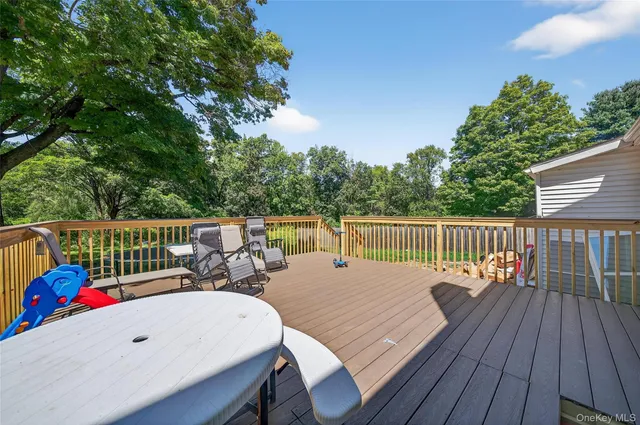 a view of a tree in front of a house with a yard
