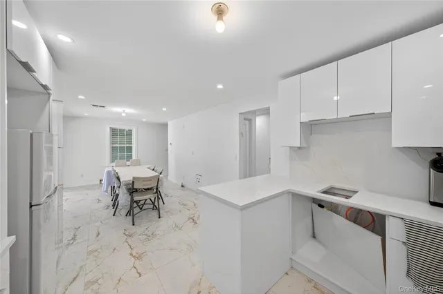 a kitchen with a sink cabinets and outdoor space