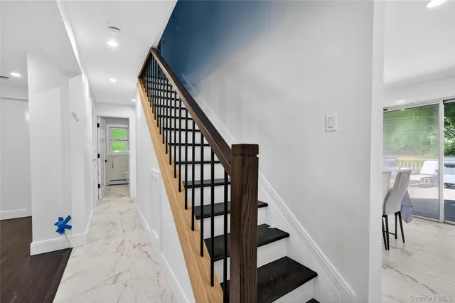 a view of entryway with wooden floor and stairs