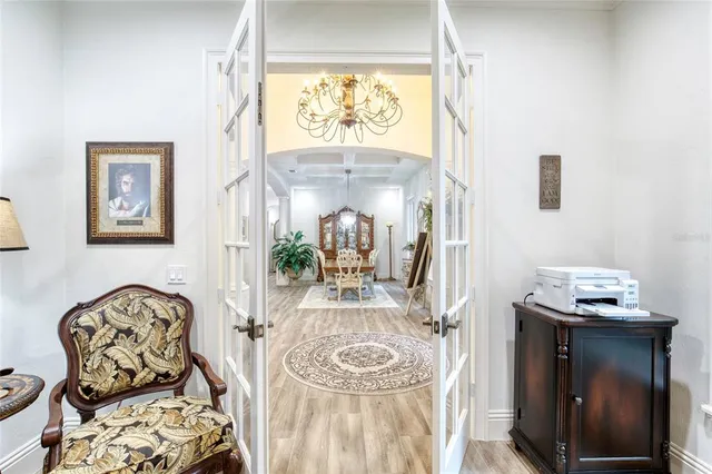 a kitchen with stainless steel appliances granite countertop a sink a stove and chairs