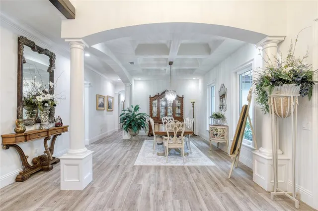 a large white kitchen with a stove a sink a refrigerator and island