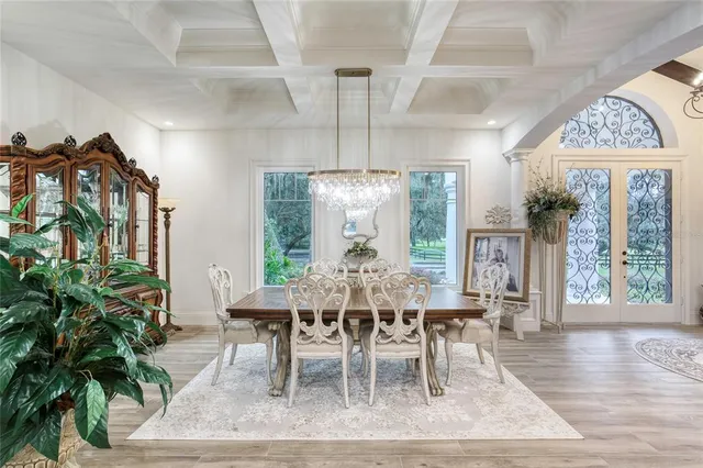 a large room with a lot of white furniture and a bath tub