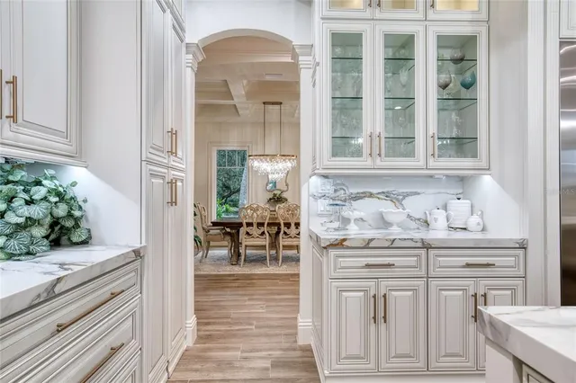 a view of a hallway with wooden floor and a potted plant
