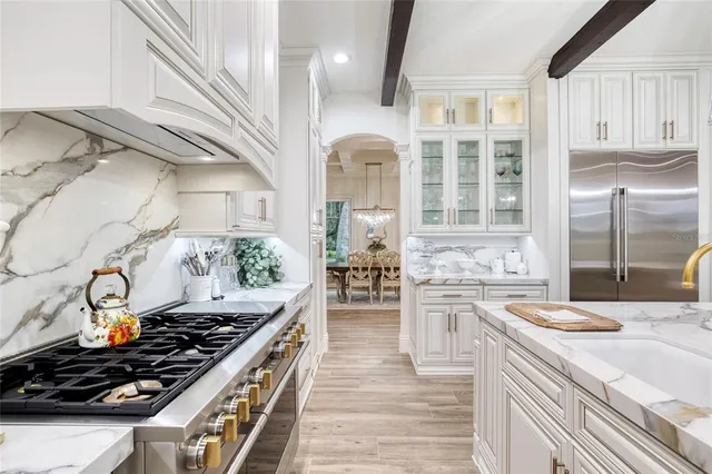 a living room with furniture floor to ceiling window and wooden floor