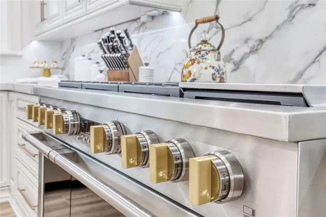 a spacious bedroom with a bed chandelier and window