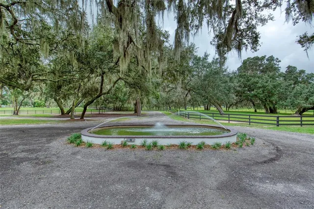 a view of a livingroom with wooden floor and a chandelier