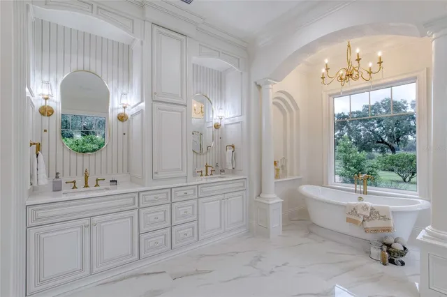 a front view of a house with a garden and trees