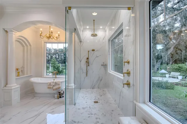 a view of a house with a big yard and large trees